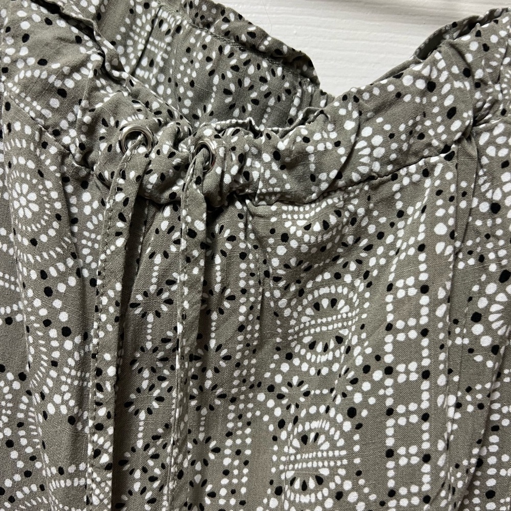 Green/black and white patterned drawstring pants.